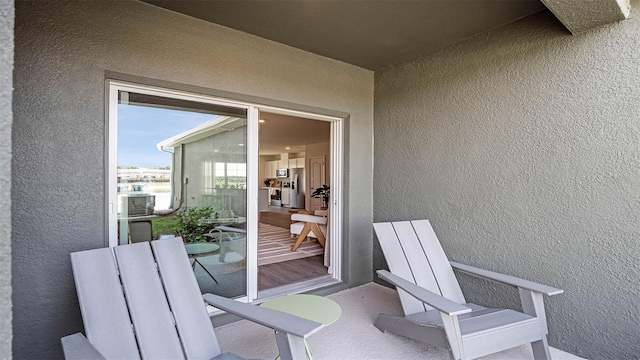 exterior space with a balcony and stucco siding