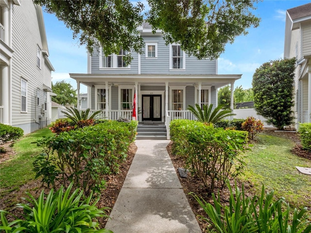 view of front facade featuring covered porch and french doors