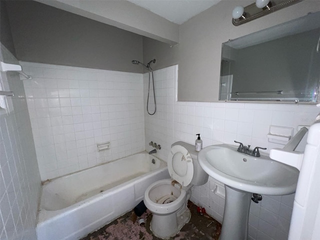 bathroom with toilet, shower / washtub combination, a wainscoted wall, and tile walls