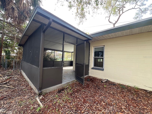 view of property exterior with a sunroom