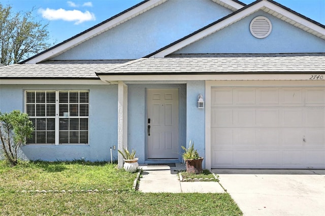 view of front of property featuring a garage, driveway, roof with shingles, and stucco siding