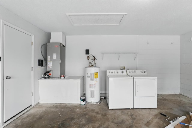 laundry area featuring laundry area, attic access, electric water heater, heating unit, and washing machine and dryer