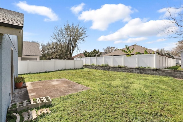 view of yard with a patio area and a fenced backyard