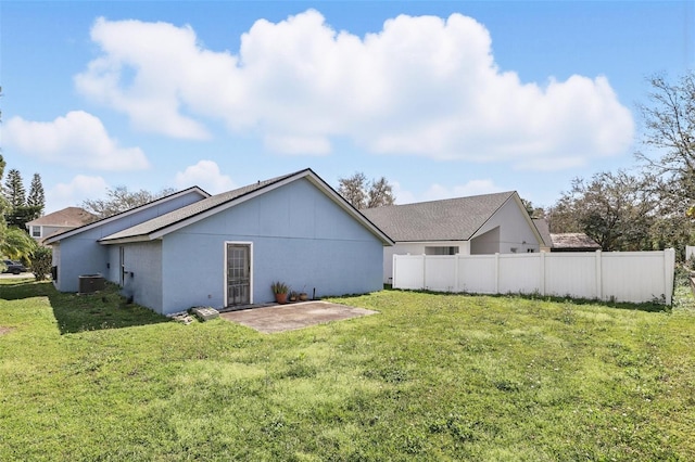 back of house featuring a patio area, fence, a lawn, and stucco siding