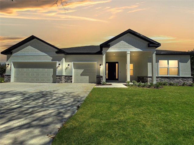 craftsman-style house featuring an attached garage, stone siding, a lawn, and stucco siding