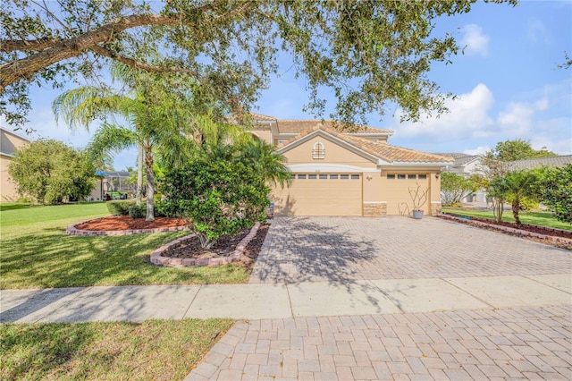 view of front facade with an attached garage, a tiled roof, decorative driveway, stucco siding, and a front lawn