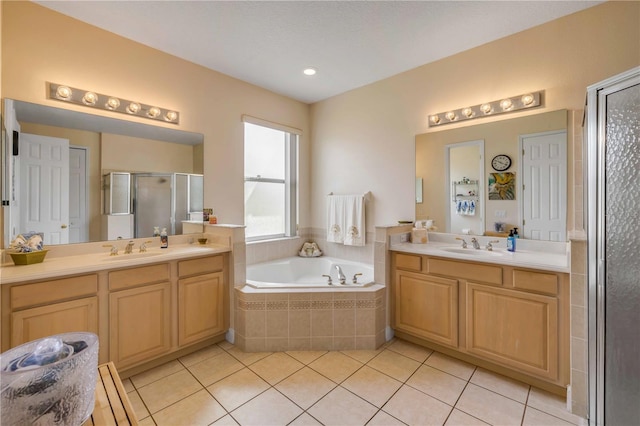 full bathroom featuring tile patterned flooring, a sink, two vanities, a shower stall, and a bath