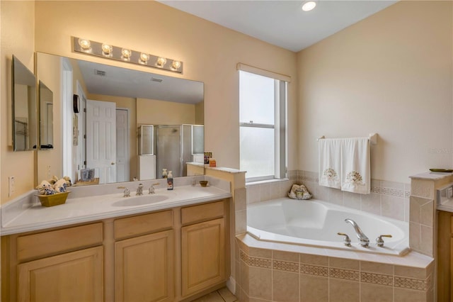 bathroom featuring a stall shower, visible vents, vanity, and a bath