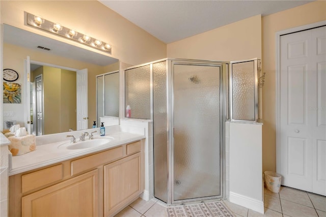 bathroom featuring a stall shower, tile patterned flooring, visible vents, and vanity