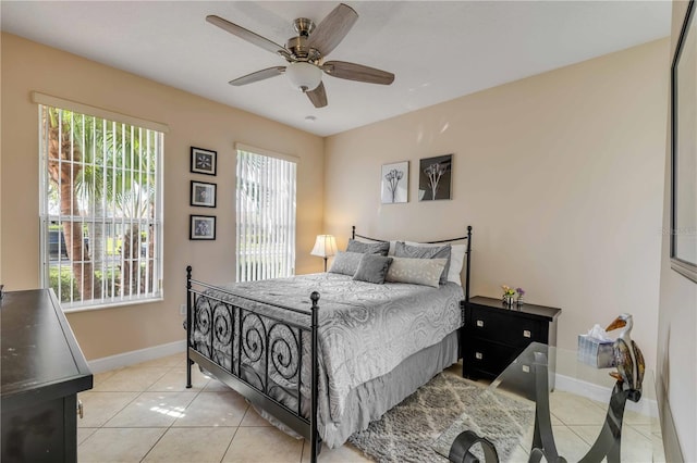 bedroom featuring a ceiling fan, light tile patterned flooring, and baseboards