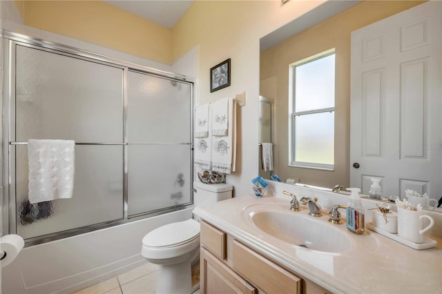 full bathroom featuring enclosed tub / shower combo, vanity, toilet, and tile patterned floors