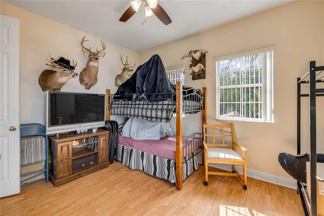 bedroom featuring baseboards and wood finished floors