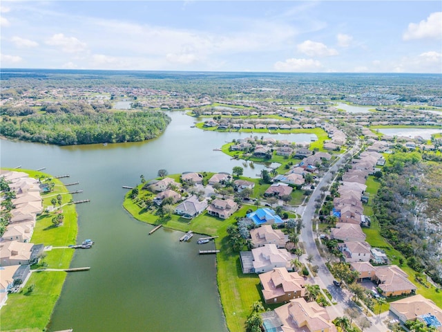 drone / aerial view featuring a residential view and a water view