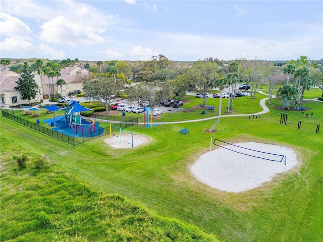 view of home's community featuring playground community and a yard