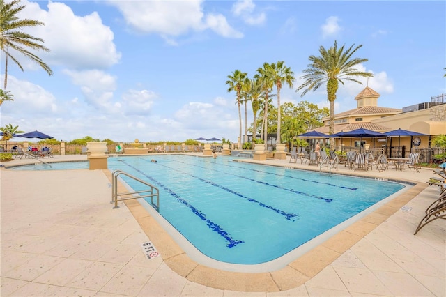 pool featuring a patio area and fence