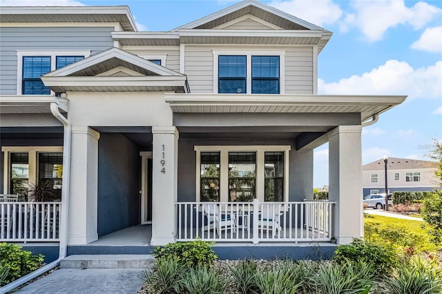 view of front of property with covered porch and stucco siding