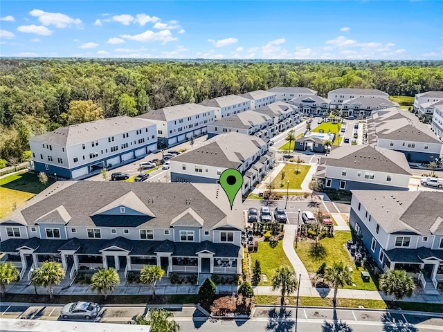 aerial view with a wooded view and a residential view