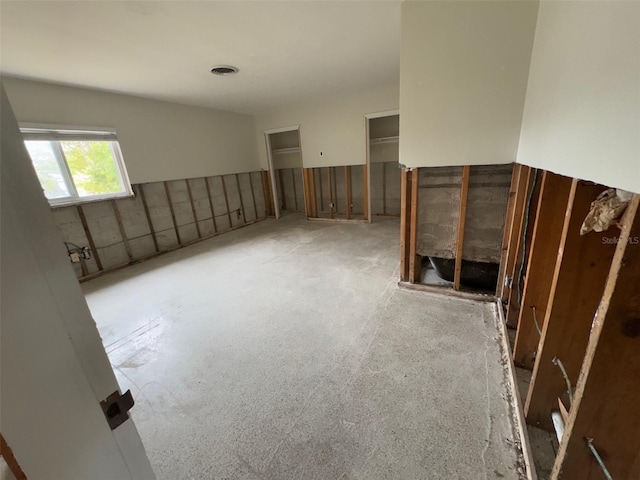 unfurnished room with visible vents