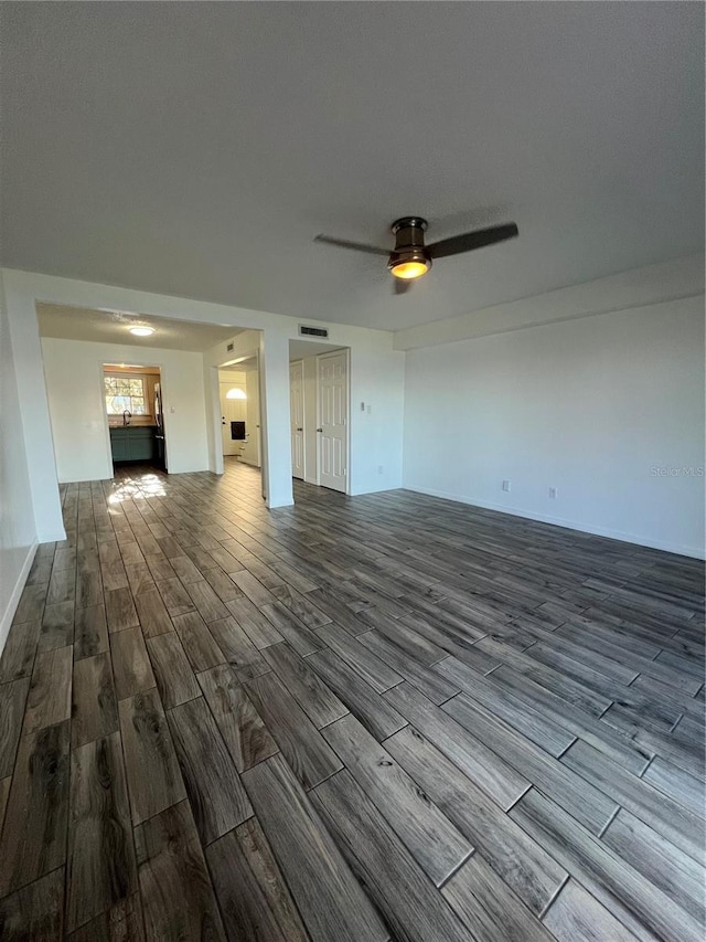 interior space featuring visible vents, ceiling fan, and wood finished floors