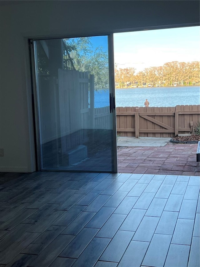 doorway to outside featuring a water view and wood finished floors