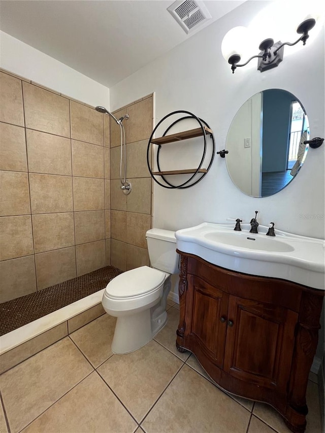 full bathroom featuring toilet, vanity, visible vents, and tile patterned floors