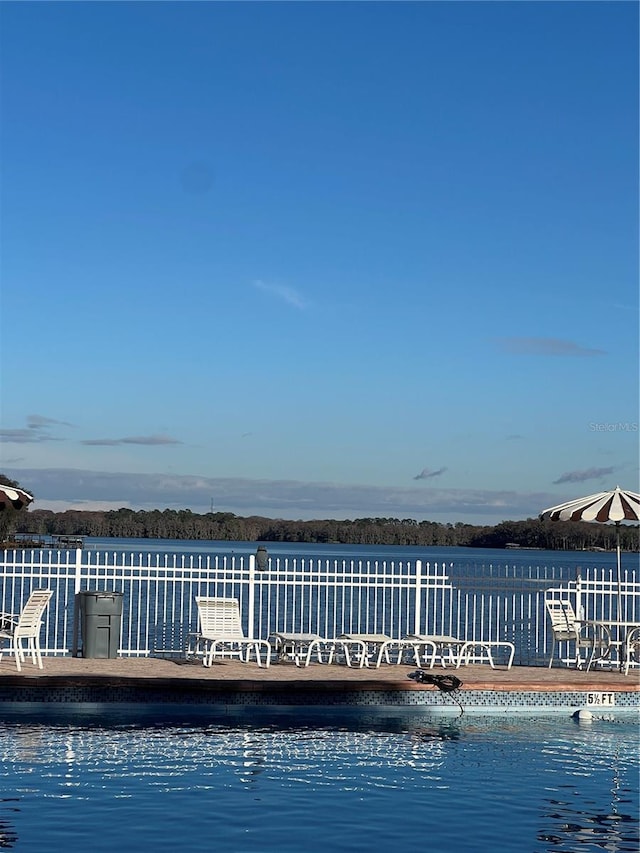 view of swimming pool featuring a water view