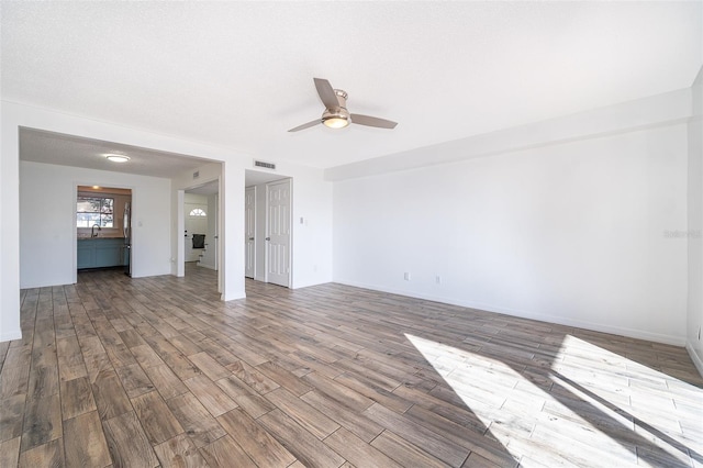 620 Georgetown Dr Unit 620, Casselberry, FL 32707 - unfurnished living room with a ceiling fan, wood finished floors, baseboards, and visible vents