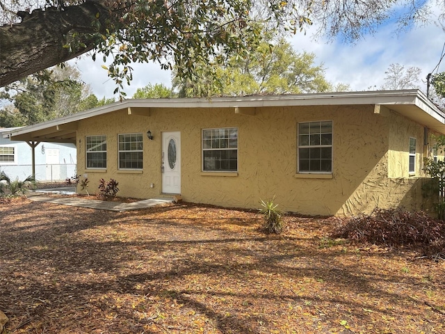 view of front of home with fence and stucco siding