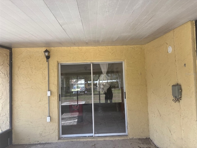 entrance to property with stucco siding