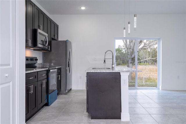 kitchen featuring pendant lighting, a sink, light stone counters, appliances with stainless steel finishes, and light tile patterned floors