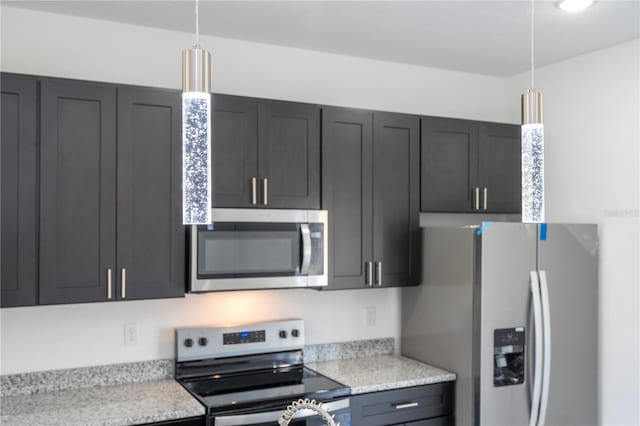 kitchen with hanging light fixtures and appliances with stainless steel finishes