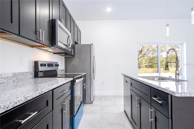 kitchen featuring pendant lighting, a sink, appliances with stainless steel finishes, light tile patterned flooring, and light stone countertops