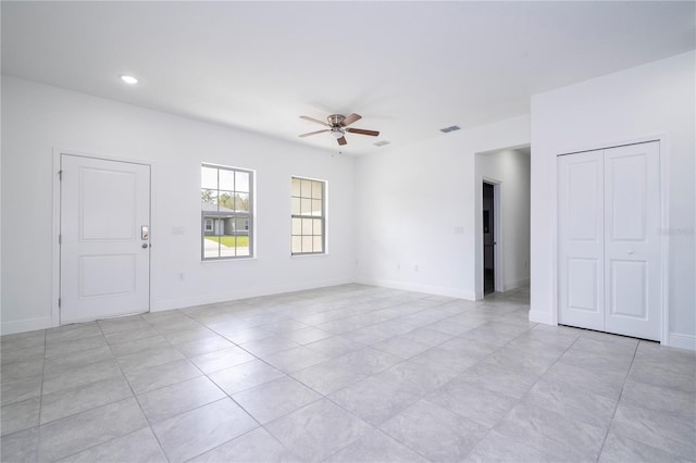 spare room with visible vents, recessed lighting, baseboards, and a ceiling fan