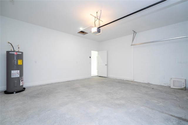 garage featuring electric water heater and a garage door opener