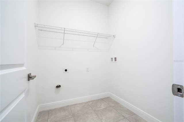 clothes washing area with baseboards, washer hookup, light tile patterned floors, laundry area, and hookup for an electric dryer