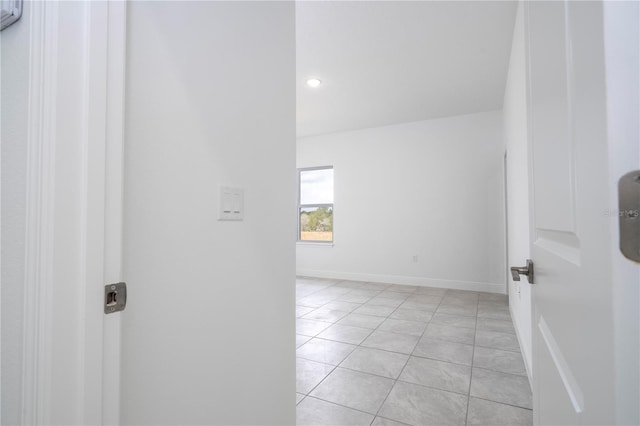 unfurnished room featuring light tile patterned floors, recessed lighting, and baseboards