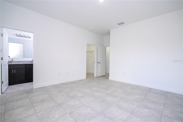 unfurnished room featuring baseboards and visible vents