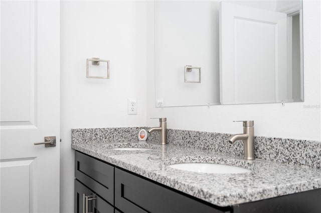 bathroom with a sink and double vanity