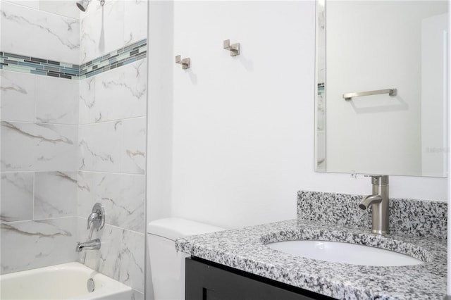 bathroom featuring toilet, vanity, and shower / bathing tub combination