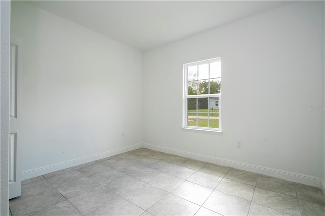 spare room with baseboards