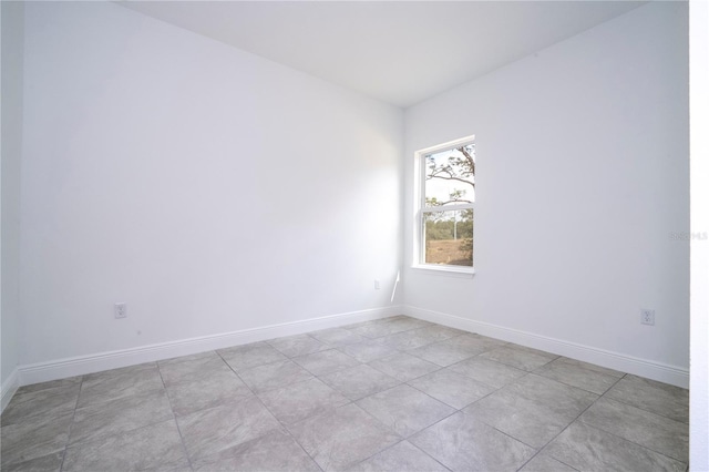 spare room with baseboards