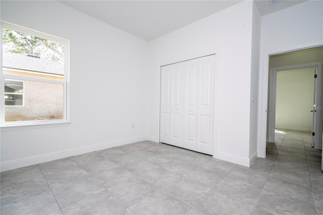 unfurnished bedroom featuring a closet and baseboards