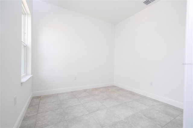 spare room featuring visible vents and baseboards