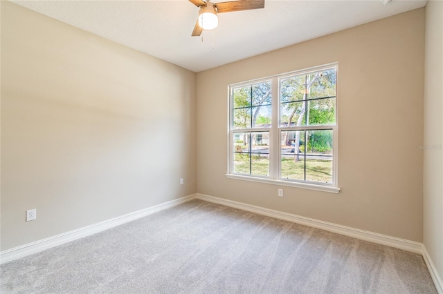 unfurnished room featuring carpet floors, baseboards, and a ceiling fan