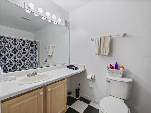 full bathroom featuring visible vents, vanity, toilet, and tile patterned floors