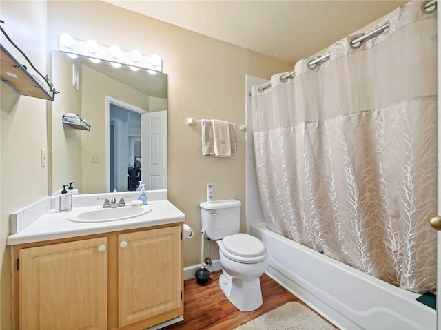 bathroom featuring shower / bathtub combination with curtain, toilet, vanity, a textured ceiling, and wood finished floors