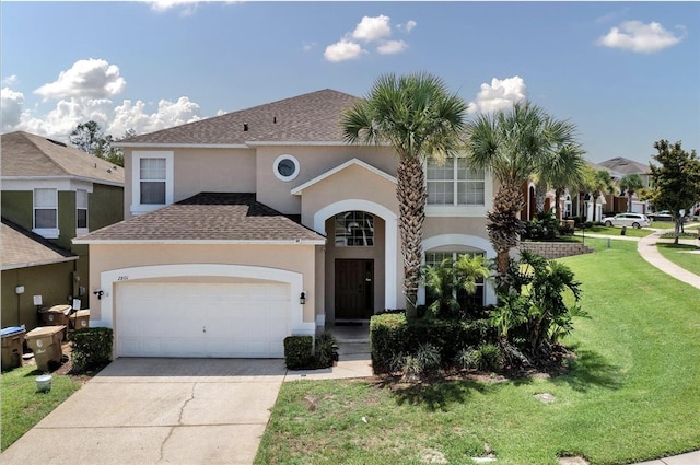 view of front facade with a garage, driveway, a front lawn, and stucco siding