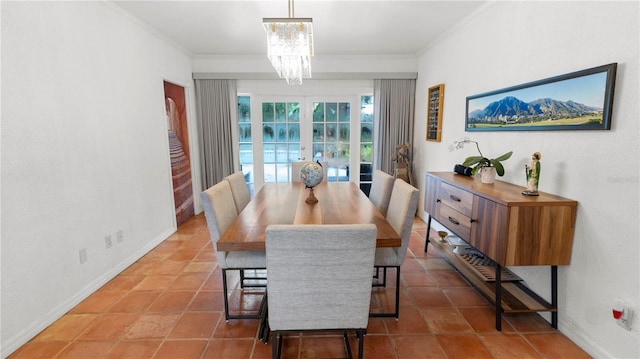 dining area with ornamental molding, french doors, baseboards, and an inviting chandelier