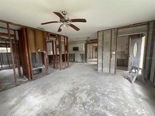 unfurnished living room featuring ceiling fan and visible vents