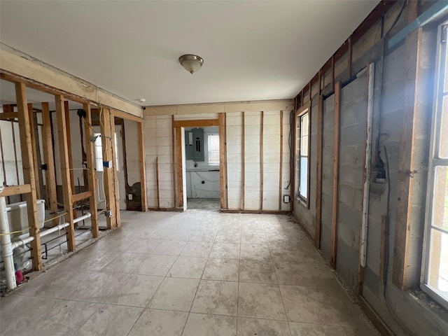 interior space with light tile patterned floors and electric panel